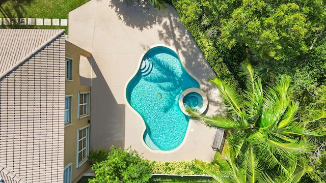 view of swimming pool featuring a patio and an in ground hot tub