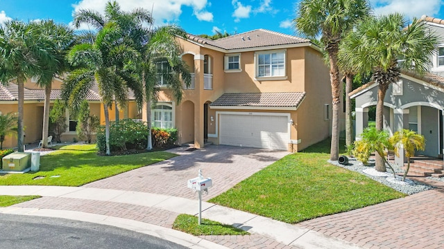 mediterranean / spanish-style home with a garage and a front yard