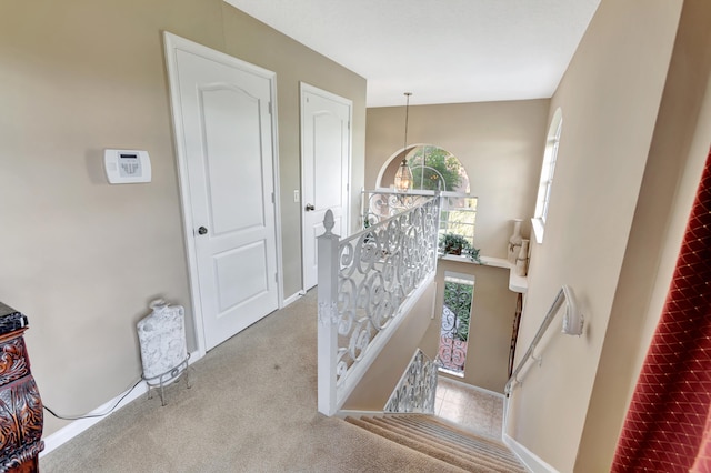 interior space featuring carpet floors and a notable chandelier