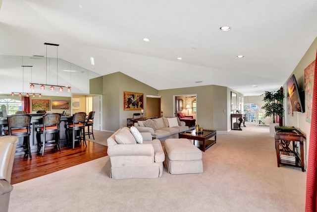 living room with light wood-type flooring and lofted ceiling