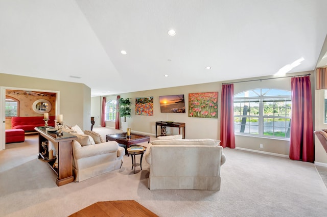 carpeted living room with vaulted ceiling