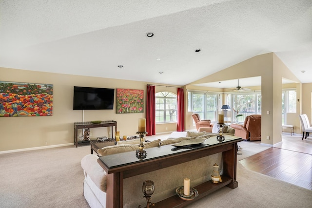 227 Legendary Cir, Palm Beach Gardens, FL 33418 - living room featuring vaulted ceiling, light carpet, a ceiling fan, baseboards, and a textured ceiling