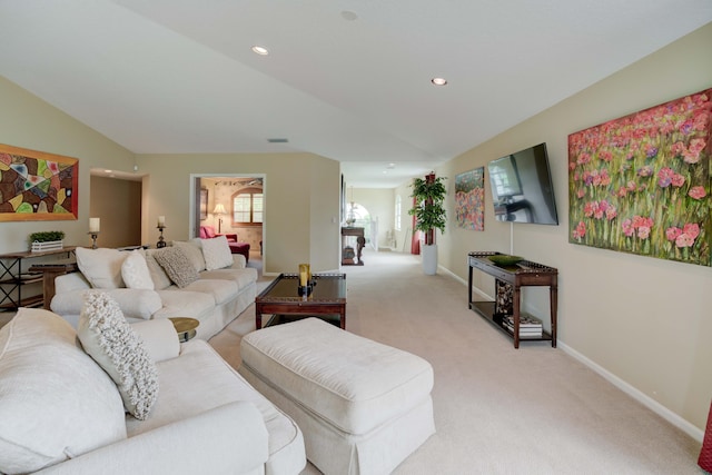 carpeted living room with vaulted ceiling