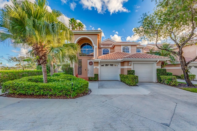 mediterranean / spanish-style house with a garage