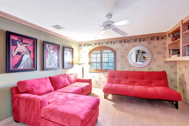 carpeted living room with a textured ceiling, ornamental molding, and ceiling fan