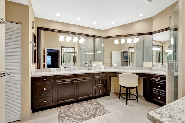 bathroom featuring an enclosed shower, vanity, and tile patterned flooring