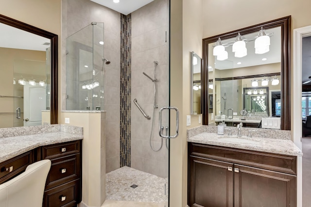 bathroom with a shower with shower door, vanity, and toilet