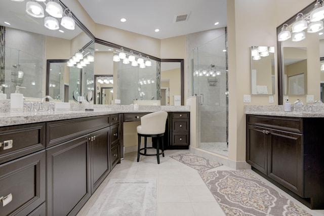 bathroom with walk in shower, vanity, and tile patterned floors