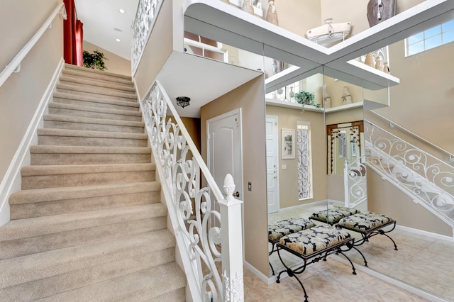 227 Legendary Cir, Palm Beach Gardens, FL 33418 - stairway featuring a high ceiling and baseboards