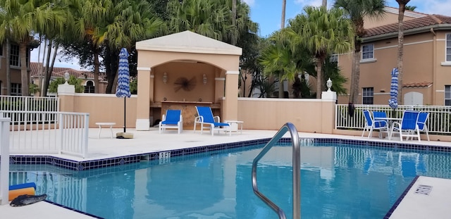 view of swimming pool with a patio area