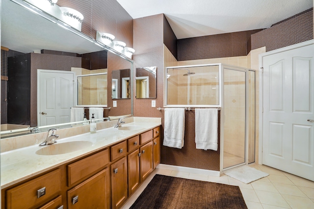 bathroom with tile patterned flooring, vanity, and an enclosed shower