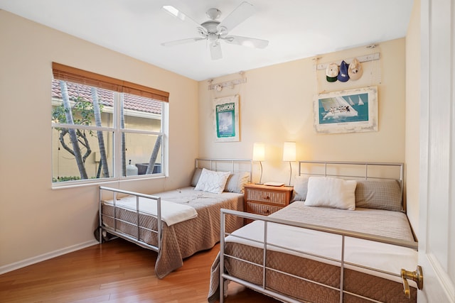 bedroom featuring hardwood / wood-style floors and ceiling fan