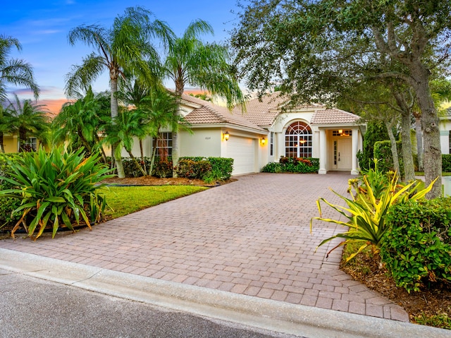 mediterranean / spanish home featuring a garage