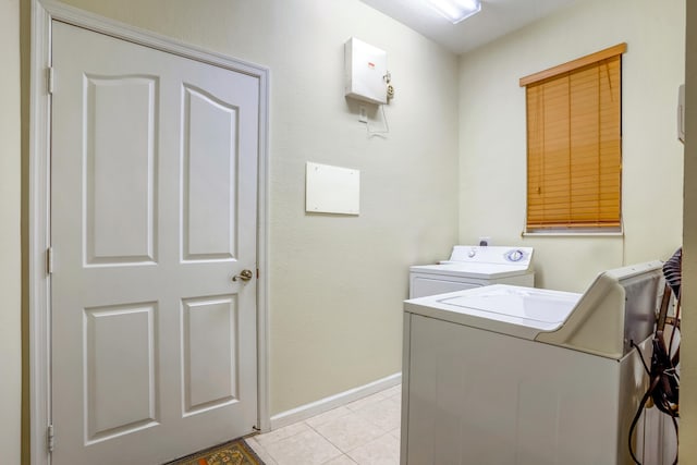 washroom featuring washing machine and dryer and light tile patterned flooring