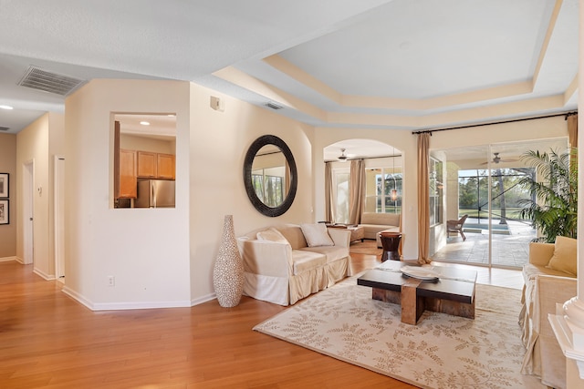 living room featuring ceiling fan and light wood-type flooring