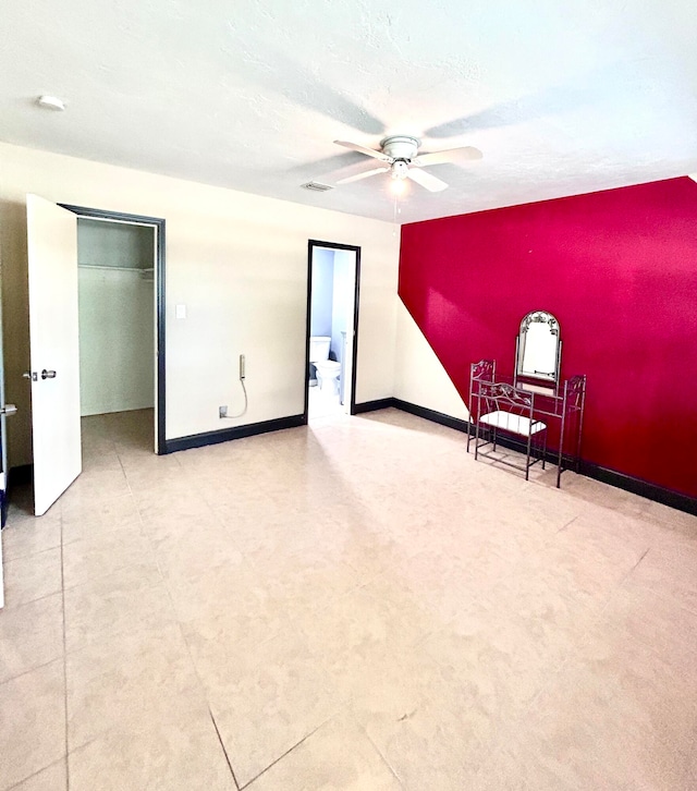 empty room with a textured ceiling and ceiling fan