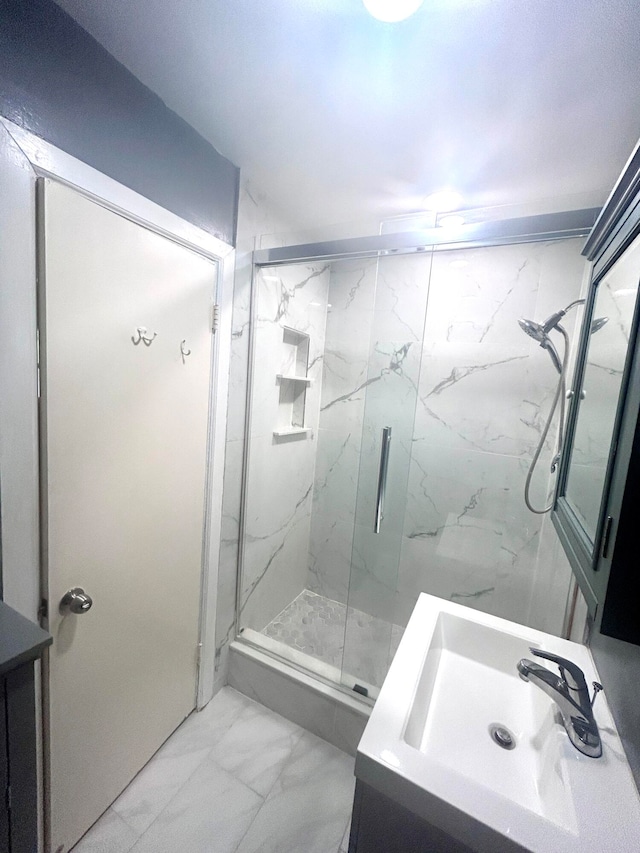 bathroom featuring sink and a shower with shower door