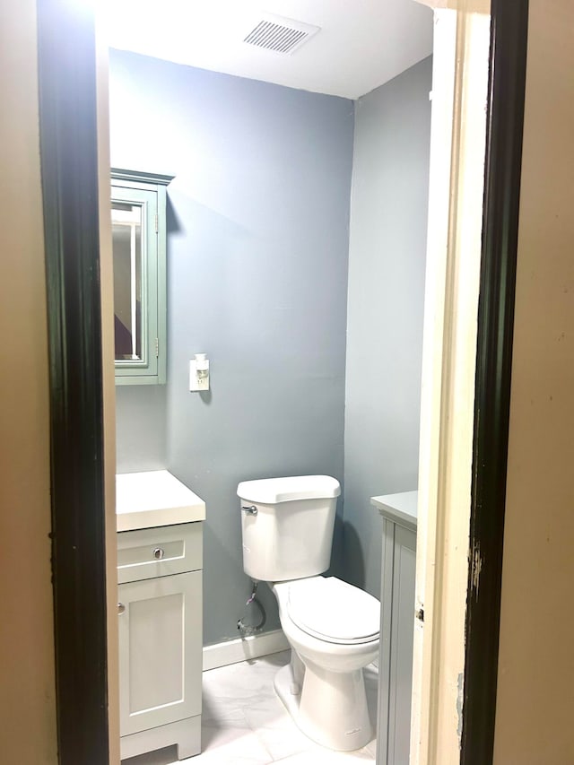 bathroom with tile patterned floors, vanity, and toilet