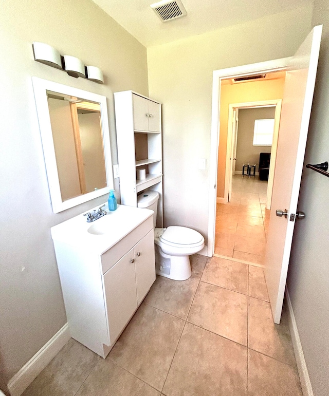 bathroom featuring tile patterned flooring, vanity, and toilet