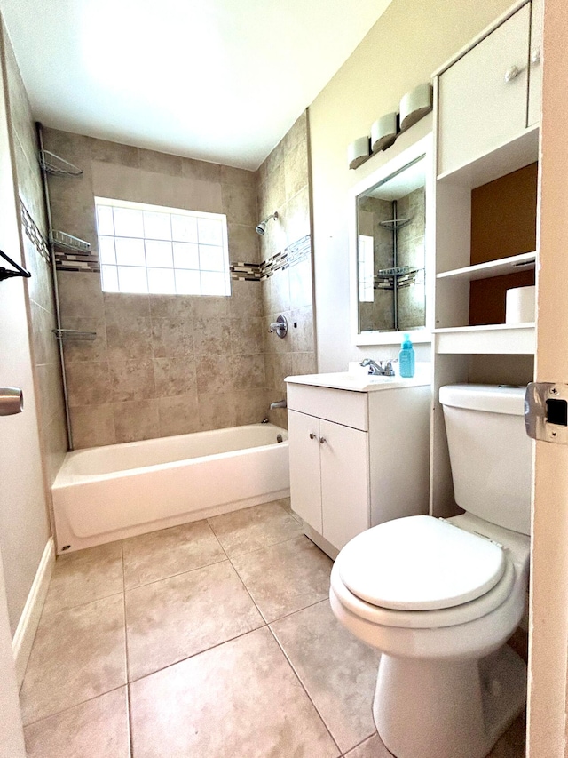 full bathroom featuring vanity, tile patterned floors, tiled shower / bath, and toilet