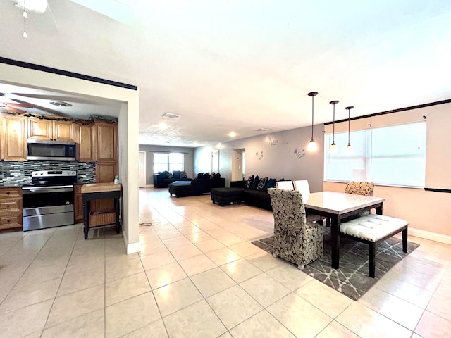 tiled dining area featuring ceiling fan