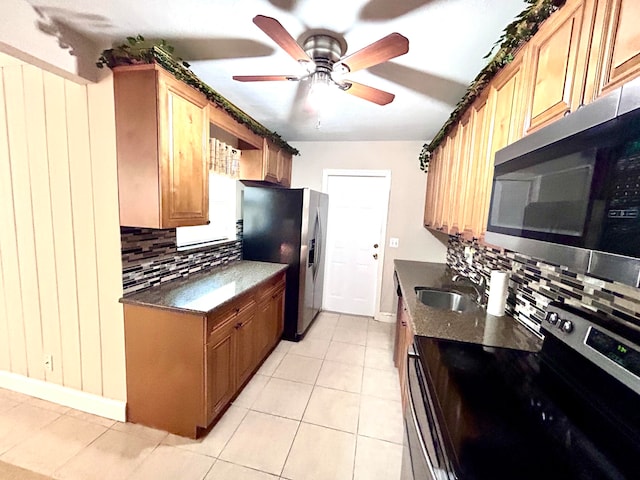 kitchen with light tile patterned floors, sink, tasteful backsplash, ceiling fan, and appliances with stainless steel finishes