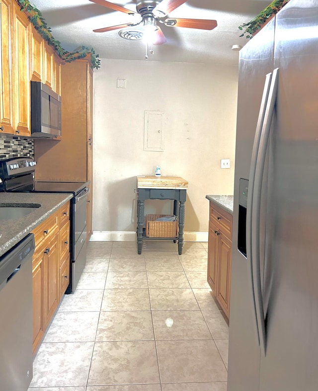 kitchen featuring tasteful backsplash, stainless steel appliances, a textured ceiling, light tile patterned floors, and ceiling fan