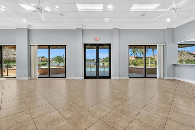 spare room featuring light tile patterned flooring, a paneled ceiling, and ceiling fan