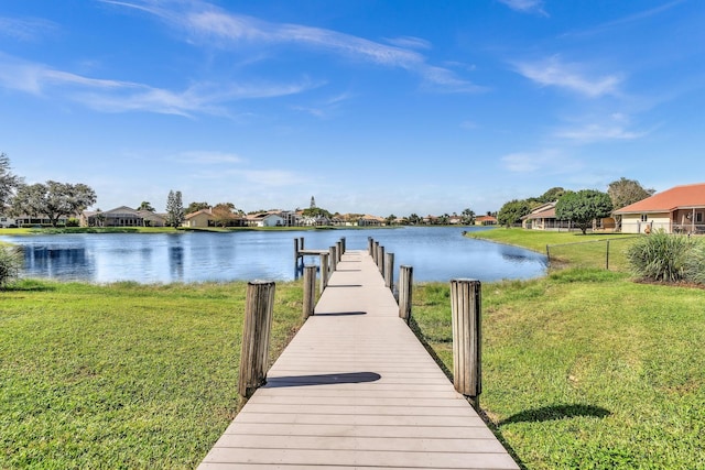 dock area featuring a water view and a lawn