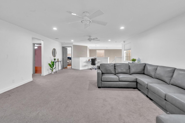 carpeted living room with ceiling fan