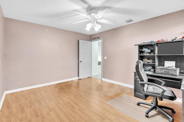 home office with ceiling fan and light wood-type flooring