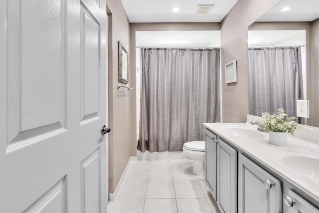 bathroom featuring vanity, tile patterned floors, toilet, and walk in shower