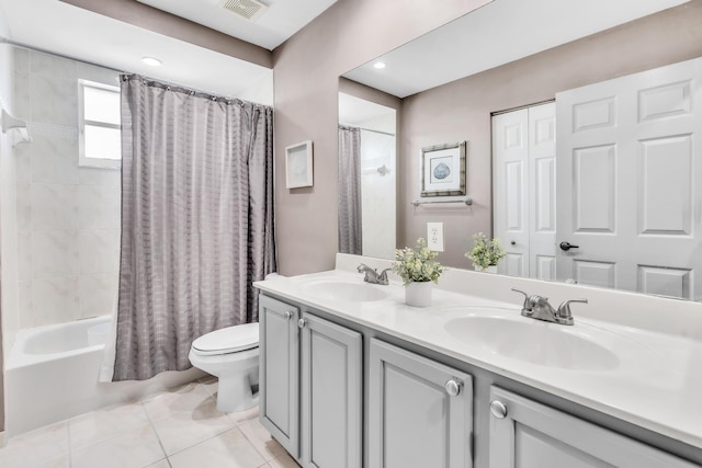 full bathroom with vanity, shower / bathtub combination with curtain, tile patterned floors, and toilet