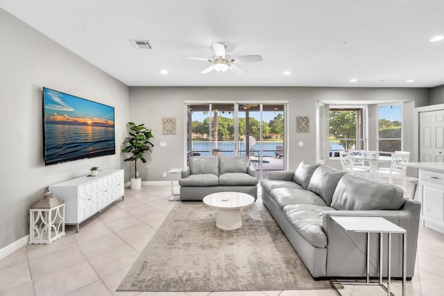 living room featuring ceiling fan and light tile patterned floors