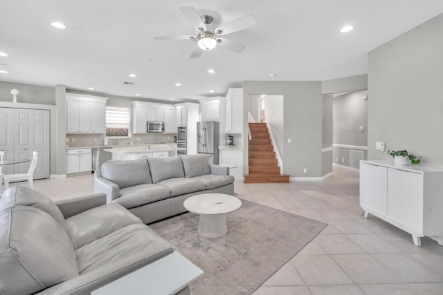 tiled living room with ceiling fan