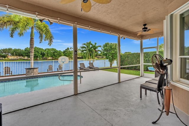 view of pool featuring a water view, ceiling fan, and a patio