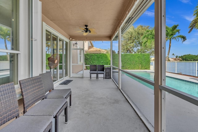 sunroom with ceiling fan