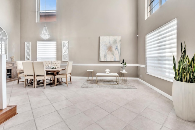 tiled dining room with a towering ceiling