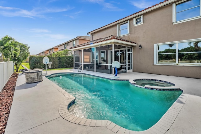 view of swimming pool featuring a fire pit, a patio area, a sunroom, and an in ground hot tub