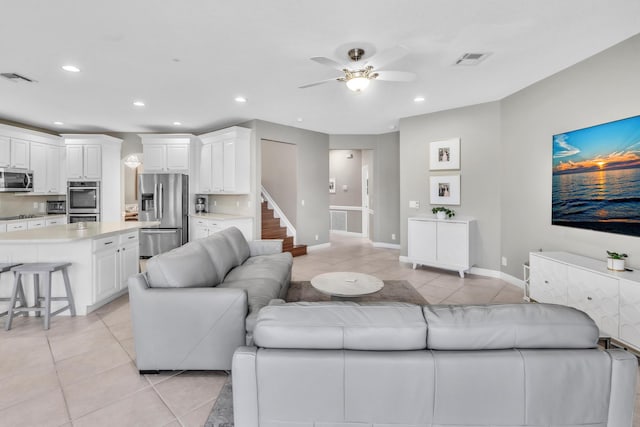 living room with ceiling fan and light tile patterned flooring