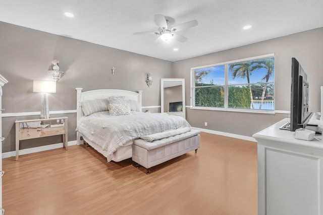 bedroom with hardwood / wood-style flooring and ceiling fan