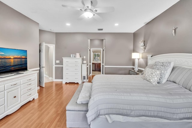 bedroom featuring light hardwood / wood-style flooring and ceiling fan