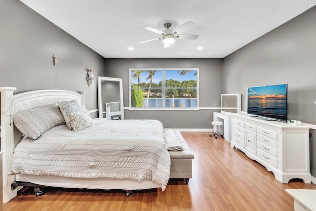 bedroom with ceiling fan and light hardwood / wood-style floors