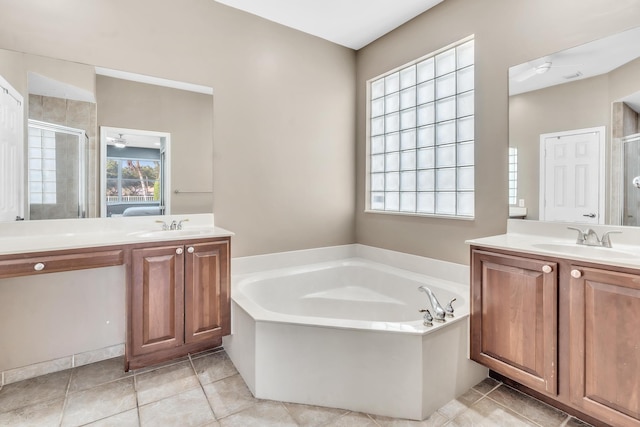 bathroom featuring vanity, plus walk in shower, and tile patterned flooring