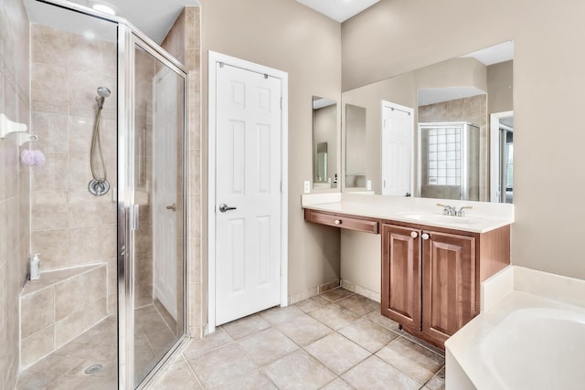 bathroom with shower with separate bathtub, vanity, and tile patterned floors