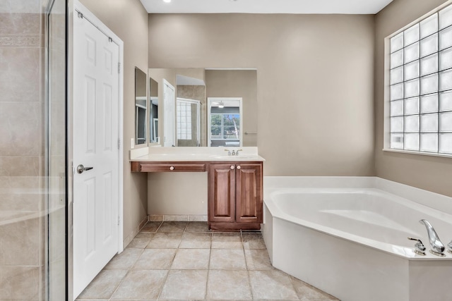 bathroom featuring plenty of natural light, shower with separate bathtub, tile patterned flooring, and vanity