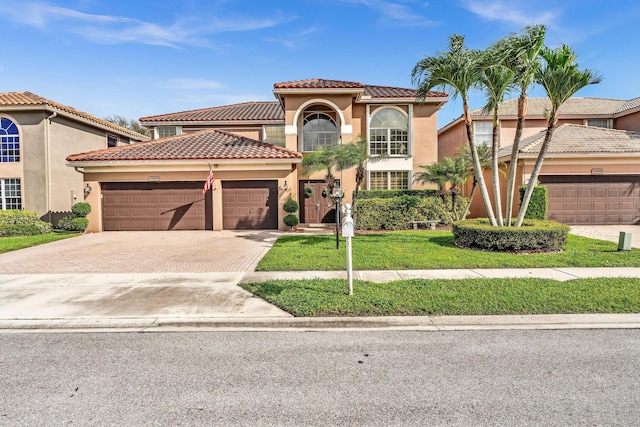 mediterranean / spanish-style house with a garage and a front lawn