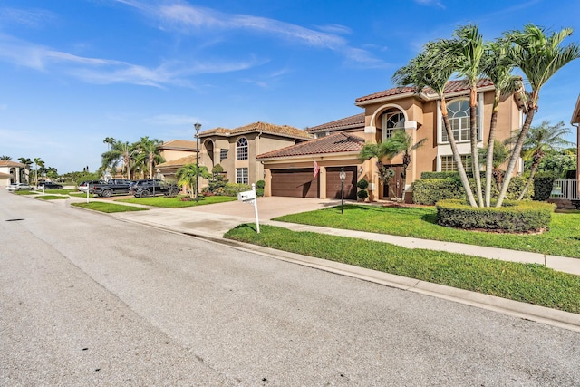 mediterranean / spanish-style home with a garage and a front lawn