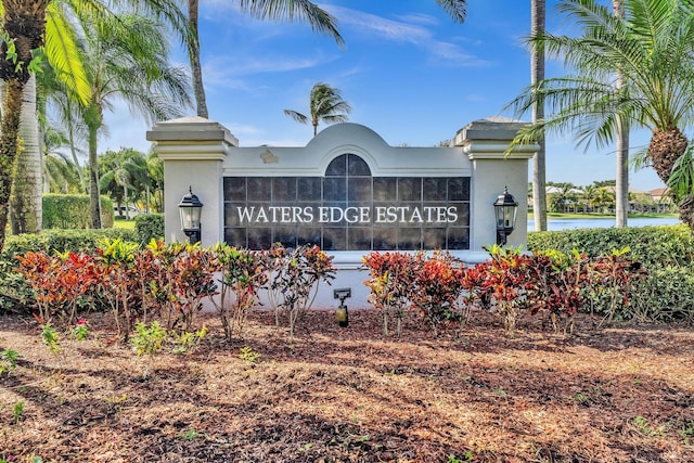 community / neighborhood sign with a water view