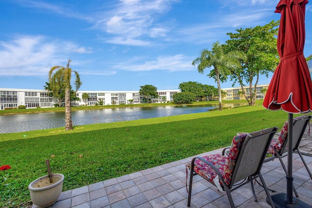 view of yard with a patio area and a water view